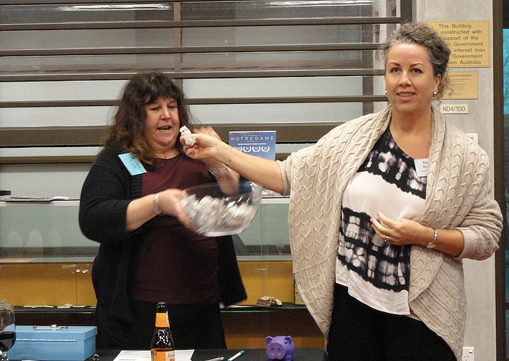 Photo: Donna Barwood commences raffle ticket draw with Michelle Murphy ensuring thorough mixing in the bowl